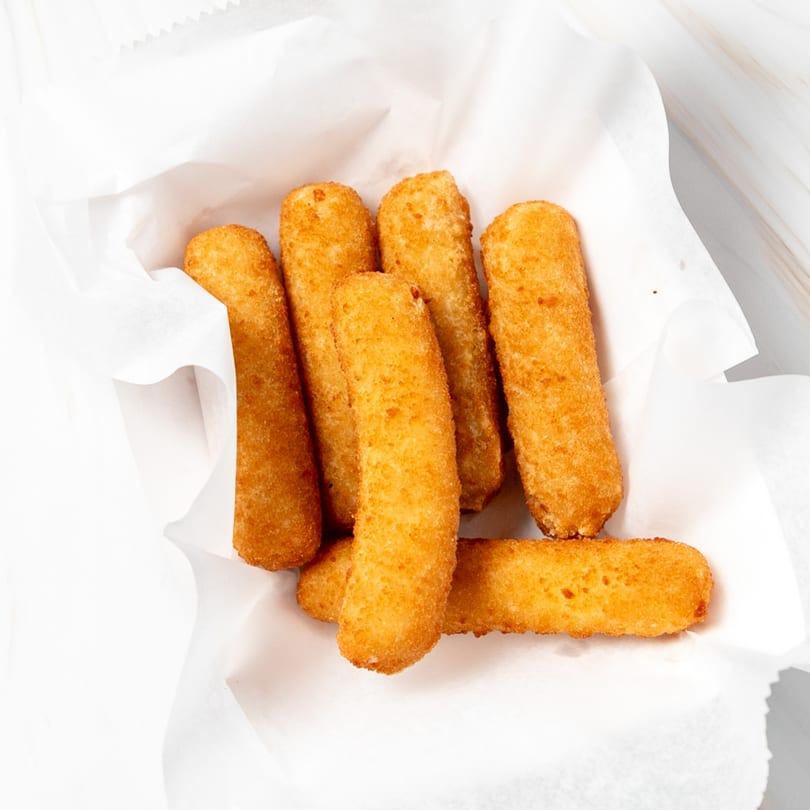 Golden-brown fried mozzarella sticks or similar seafood appetizers served in a white paper-lined basket.