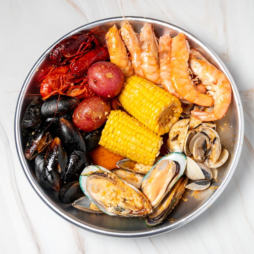 Shake Shake Seafood Monroe's seafood boil with crawfish, shrimp, mussels, clams, potatoes, and corn.